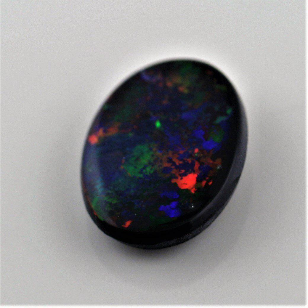 5.82 Carat Black Opal Oval Cabochon - Multi - Color Red Blue Green Fire - Gemstone Portal