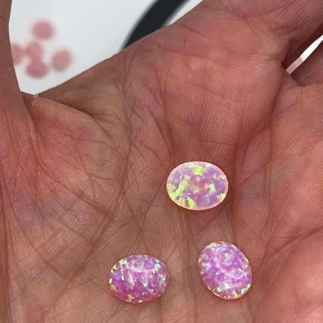 Multiple 10x8mm reconstructed pink fire opal oval cabochons video